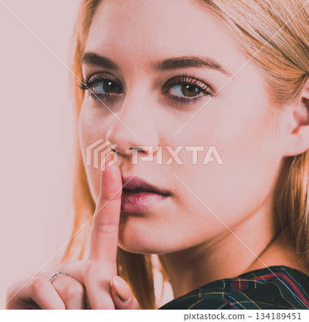 Woman showing silence gesture 134189451