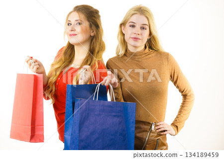 Two fashionable women with shopping bags 134189459