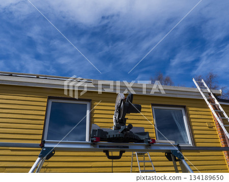 New residential construction wooden house framing against a blue sky New residential construction wooden house framing against a blue sky 134189650