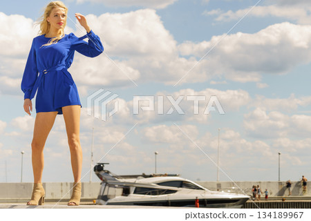 Fashion model wearing blue jumpsuit Fashion model wearing blue jumpsuit 134189967
