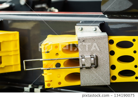 Yellow brake stop blocks wedges on red tractor 134190075