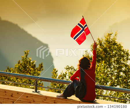 Tourist enjoy fjord view on Stegastein viewpoint Norway 134190180