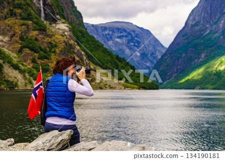 Tourist with camera on fjord, Norway Tourist with camera on fjord, Norway 134190181