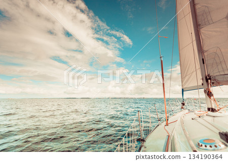 Yachting on sail boat during sunny weather Yachting on sail boat during sunny weather 134190364