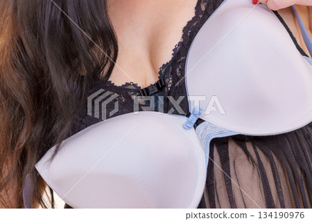 Plus size woman choosing bra to wear Plus size woman choosing bra to wear 134190976