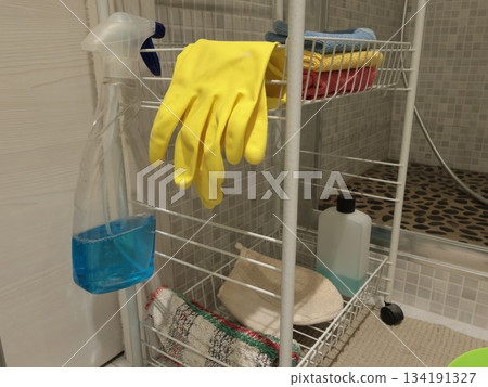 Rubber gloves and bathroom cleaning products on shelf. Health, cleanliness and hygiene. Interior design and furniture in modern flat. Rubber gloves and bathroom cleaning products on shelf. Health, cleanliness and hygiene. Interior design and furniture in modern flat. 134191327