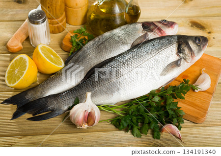 Raw sea bass on cutting board Raw sea bass on cutting board 134191340