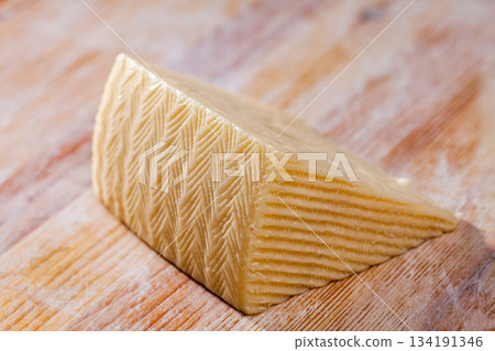 Piece of fresh semi-soft cheese 134191346