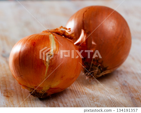 Onion bulbs on wooden background, nobody 134191357