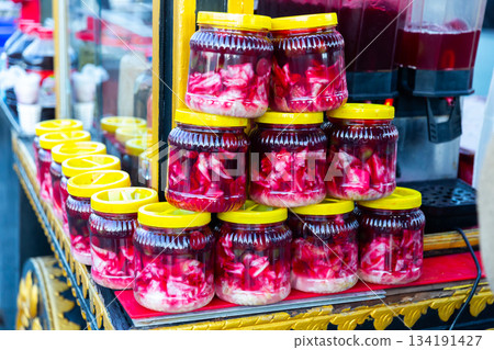 Glass jars with traditional Turkish pickles Salgam for sale 134191427
