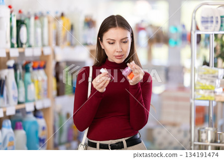 Woman choosing nail polishes Woman choosing nail polishes 134191474