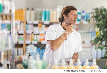 Adult man chooses prescription medications Adult man chooses prescription medications 134191539