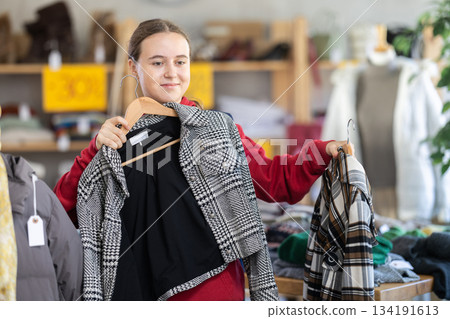 Teenage girl at winter clothes sale Teenage girl at winter clothes sale 134191613
