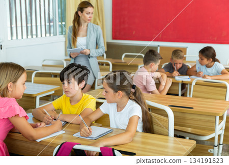 Tweens working in small groups during lesson at school 134191823