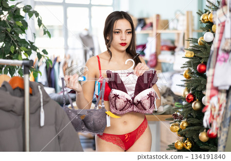 Young woman chooses underwear in clothing store Young woman chooses underwear in clothing store 134191840