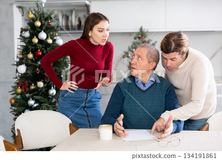 Adult children argue with each other and show their mature father how to fill out documents correctly Adult children argue with each other and show their mature father how to fill out documents correctly 134191861