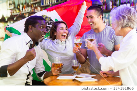 Joyful fans of the Mexican team celebrating the victory in night bar Joyful fans of the Mexican team celebrating the victory in night bar 134191966