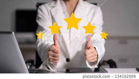 Happy asian businesswoman giving a thumbs up gesture with star ratingof approval and success. Happy asian businesswoman giving a thumbs up gesture with star ratingof approval and success. 134192009