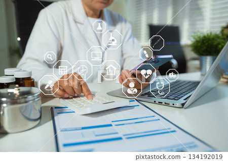 Doctor working in hospital use calculator, Healthcare and medical concept. 134192019