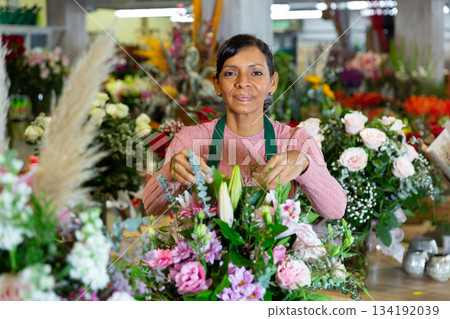 Flower seller prepares a luxury bouquet at flower shop Flower seller prepares a luxury bouquet at flower shop 134192039