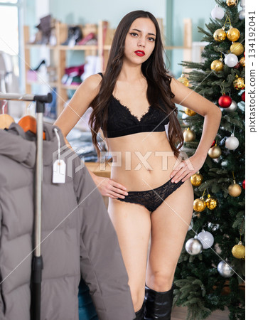 Young woman tries on lace lingerie in clothing store Young woman tries on lace lingerie in clothing store 134192041