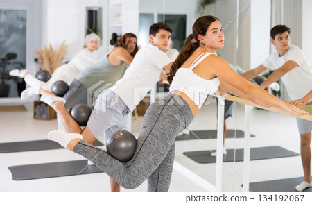 Young woman practicing pilates with ball in gym room 134192067