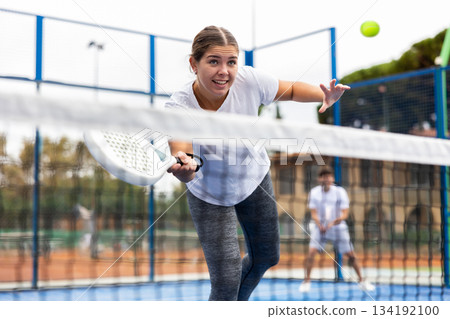 Young sporty woman playing paddle tennis outdoors Young sporty woman playing paddle tennis outdoors 134192100