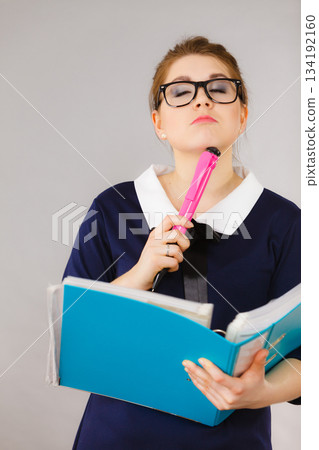 woman thinking holds file folder with documents woman thinking holds file folder with documents 134192160