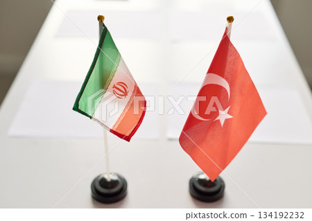 Iran and Turkey desk flags on conference table showing diplomacy and negotiations Iran and Turkey desk flags on conference table showing diplomacy and negotiations 134192232