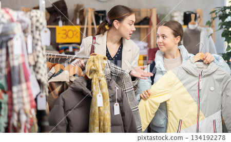 Adult woman and teenage girl choose down jacket 134192278