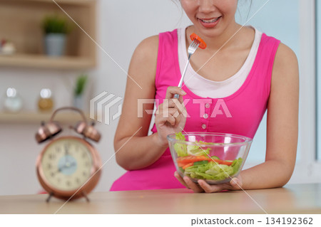 Healthy Lifestyle. Woman enjoying a fresh salad, promoting wellness and mindful eating. Healthy Lifestyle. Woman enjoying a fresh salad, promoting wellness and mindful eating. 134192362
