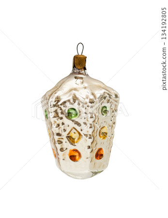Vintage glass Christmas ornament with faceted textured surface and colorful raised dots, isolated on white background. 134192805