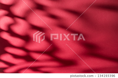 Soft gradient red background with gentle shadows, creating a serene atmosphere 134193396