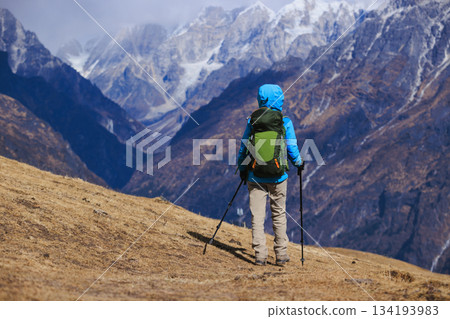Backpacking woman hiking on high altitude mountain top Backpacking woman hiking on high altitude mountain top 134193983