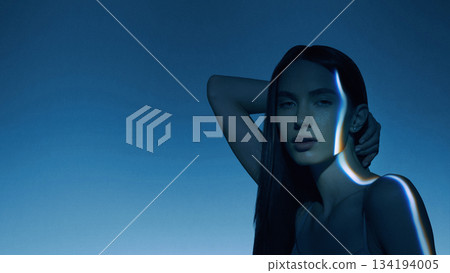 Cinematic poster of female portrait touched by curved glowing light streak. Cinematic poster of female portrait touched by curved glowing light streak. 134194005