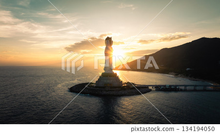 Guanyin statue at seaside in nanshan temple, hainan island , China. Words mean mercy and blessing. 134194050