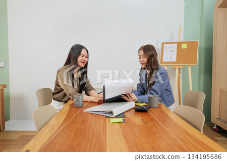 Busy office women meet, people discussing work documents and market strategy, demonstrating effective team collaboration for professional growth, sharing ideas. Busy office women meet, people discussing work documents and market strategy, demonstrating effective team collaboration for professional growth, sharing ideas. 134195686