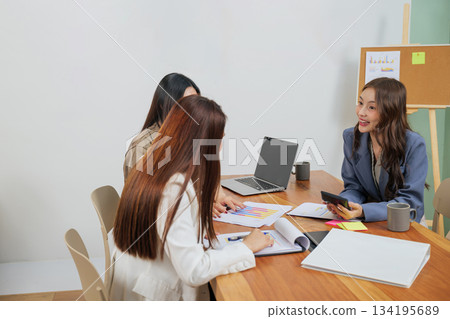 Busy office work, young women meet, market team collaborates on business strategy, analyzing financial data for success, professional people discuss ideas in modern workspace. Busy office work, young women meet, market team collaborates on business strategy, analyzing financial data for success, professional people discuss ideas in modern workspace. 134195689