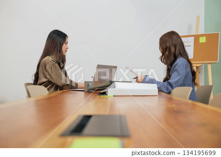Busy office work people meet, business women team members review project documents, collaborating on market strategy, focused professionals achieving goals in modern conference room. Busy office work people meet, business women team members review project documents, collaborating on market strategy, focused professionals achieving goals in modern conference room. 134195699