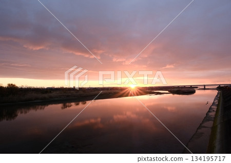 A tranquil scene with the morning sun reflected on the river surface 134195717