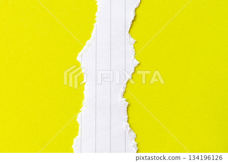 Ripped white paper with lined texture on a bright yellow background. The torn edge creates a contrast between the two colors. Ripped white paper with lined texture on a bright yellow background. The torn edge creates a contrast between the two colors. 134196126