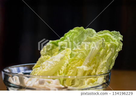 Fresh of napa lettuce or Chinese cabbage leave isolate in black background. Fresh of napa lettuce or Chinese cabbage leave isolate in black background. 134196229