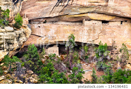 Sunset House ruins sit on upper and lower ledges in Cliff Canyon at Mesa Verde National Park, Colorado. Ancient Ancestral Puebloan cliff dwelling is visible from Sun Point View in UNESCO World Sunset House ruins sit on upper and lower ledges in Cliff Canyon at Mesa Verde National Park, Colorado. Ancient Ancestral Puebloan cliff dwelling is visible from Sun Point View in UNESCO World 134196481