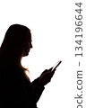 Silhouette of young woman using smartphone on white background 134196644