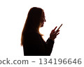 Silhouette of young woman using smartphone on white background 134196646