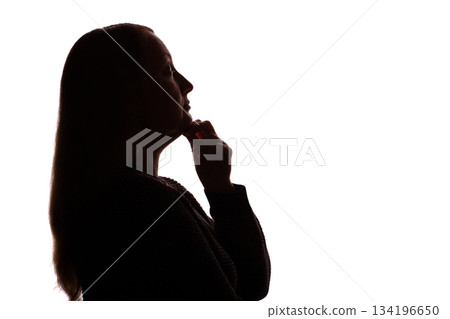 Silhouette of young woman touching her chin thoughtfully, white background 134196650