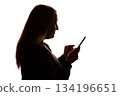 Silhouette of young woman using smartphone on white background 134196651