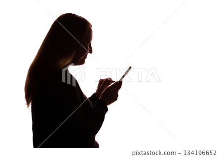 Silhouette of young woman using smartphone on white background 134196652