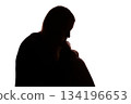 Silhouette of young woman sitting with loose hair, depressed 134196653