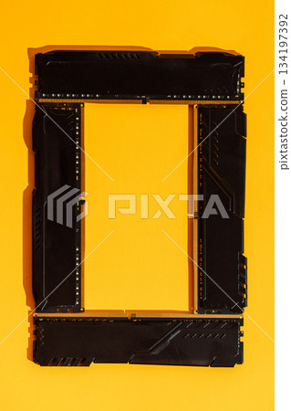Frame made of RAM modules on bright yellow background 134197392
